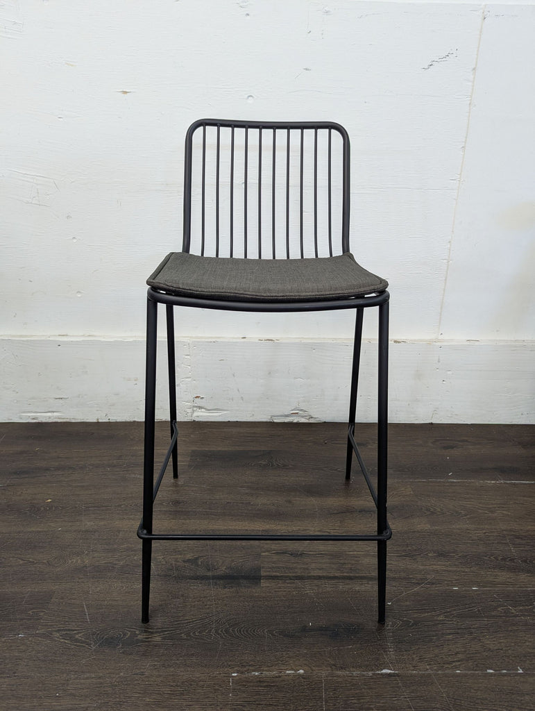 Pair of sleek black bar stools with minimalist design, suitable for kitchen counters or bars.  
