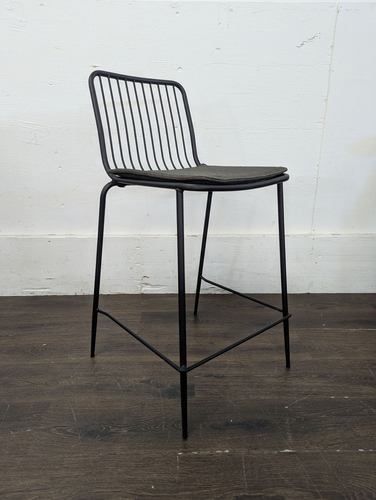 Project 62 counter stools, two-pack, featuring upholstered seats and slim metal legs for contemporary spaces.