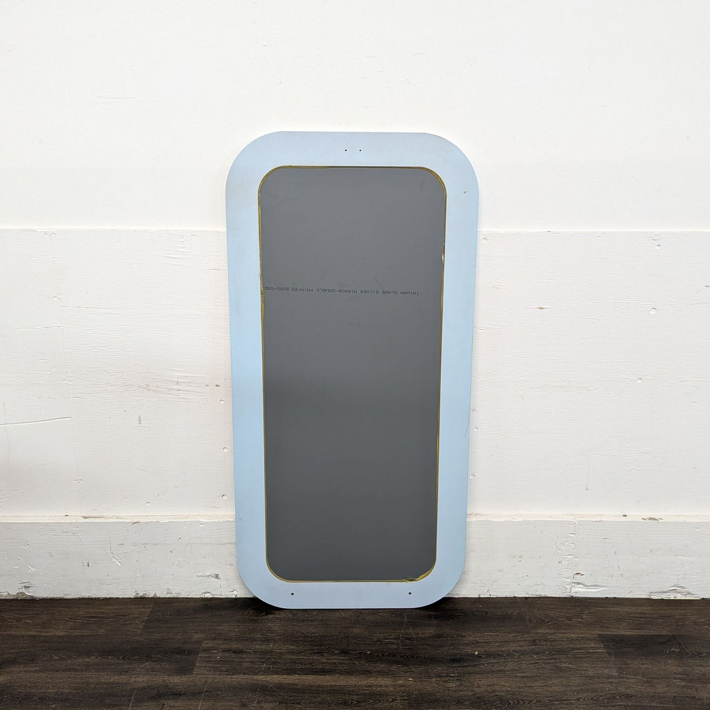 2. Close-up of Ikea mirror showing its smooth reflective surface and minimalist design.