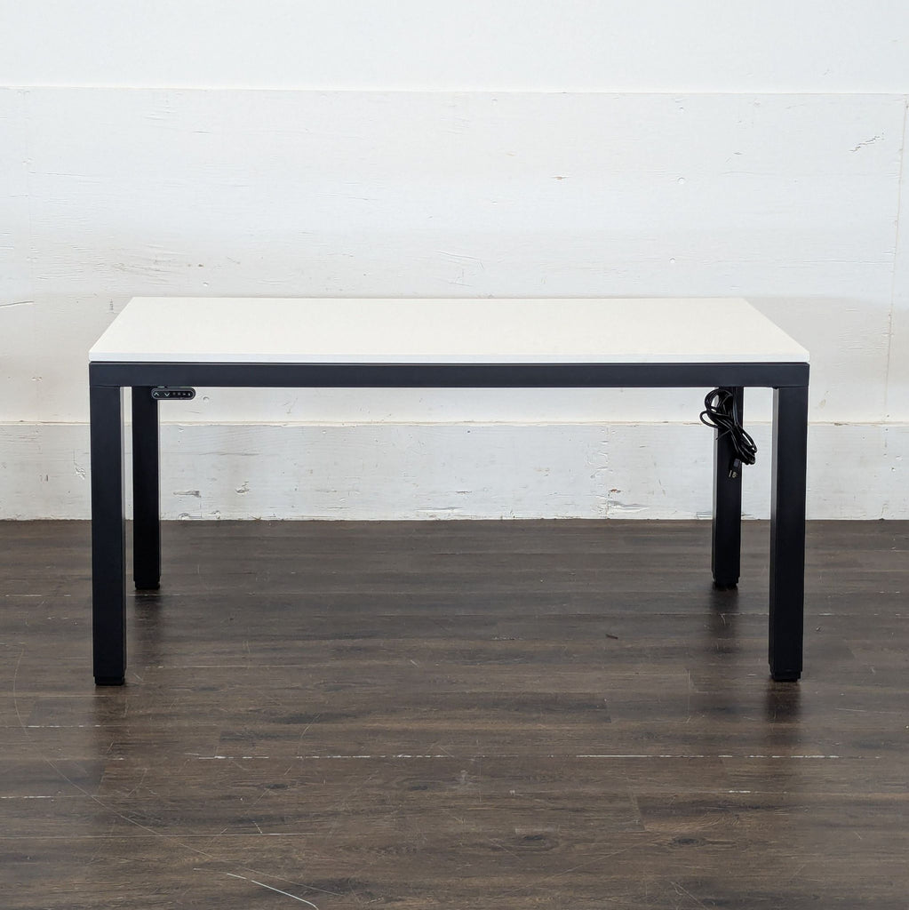 2. Sleek Parsons brand desk, featuring a simple wooden tabletop and straight, unadorned sides.