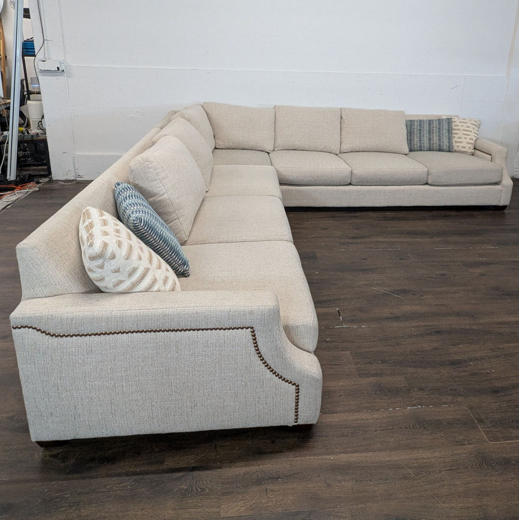 Beige L-shaped sectional sofa by Haverty's, clean upholstery, gently used, photographed in well-lit indoor setting.