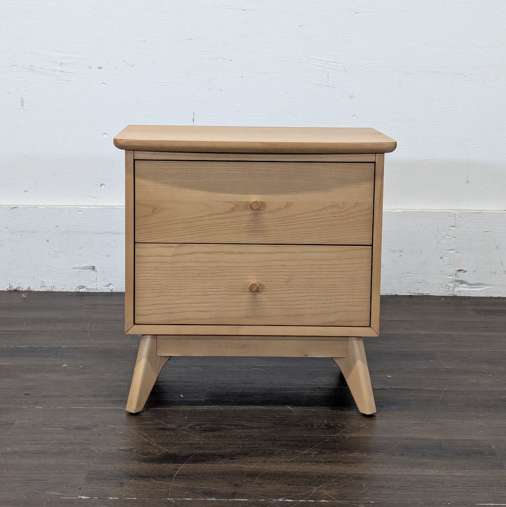 1. Modern wooden end table with a square tabletop and slim, tapered legs in a living room setting.