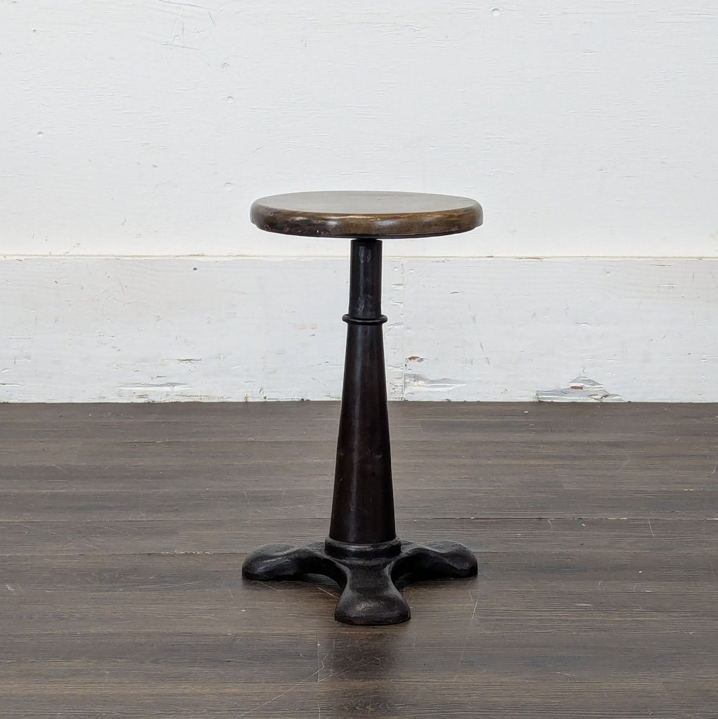 1. Industrial-style stool with a round wooden seat and black metal base, ideal for various seating needs.