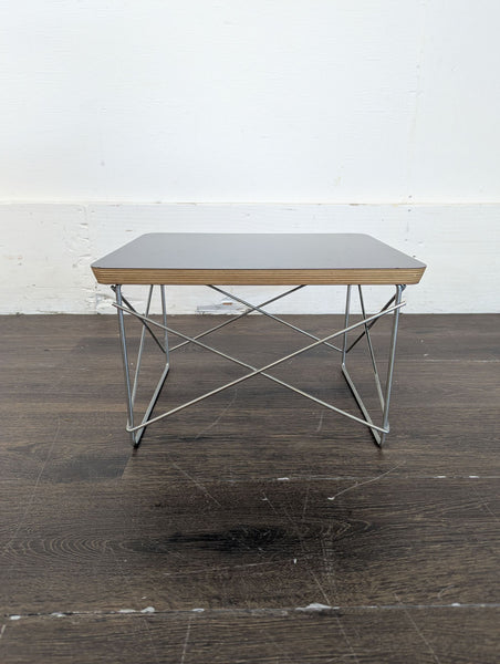 1. Wooden entertainment center with a built-in foldable end table, designed for versatile living spaces.