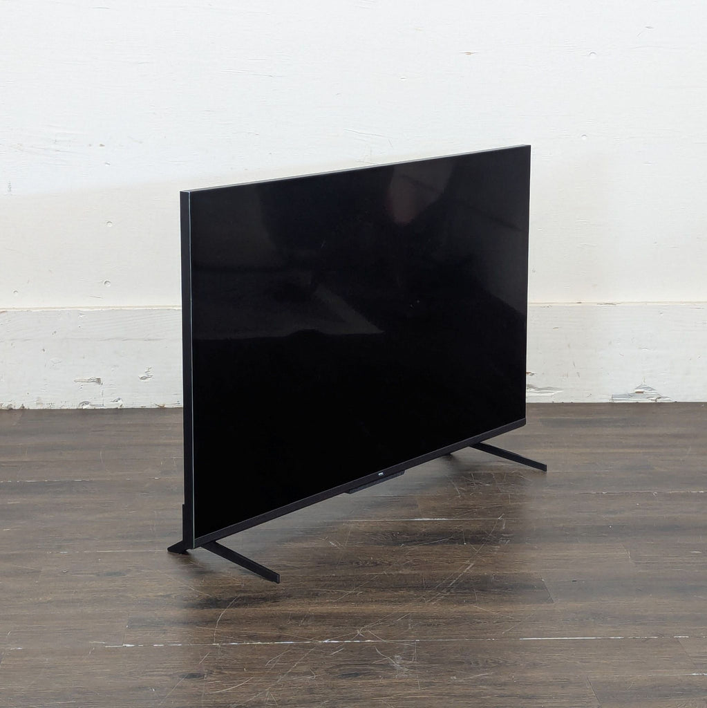 3. TCL R646 smart TV mounted on a sturdy stand, ideal for enhancing any TV viewing experience.
