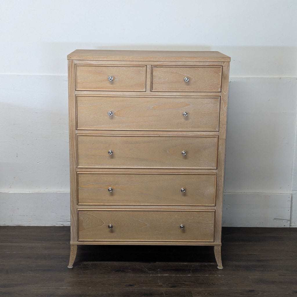 2. Tall, natural finish Arhaus dresser with six drawers and round metal handles against a white wall background.