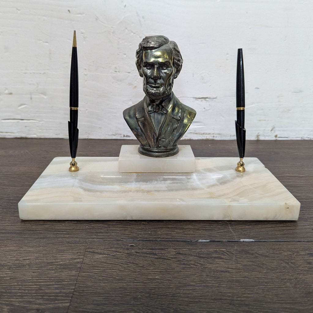 Bronze human figure sculpture positioned gracefully, displayed against neutral background.  