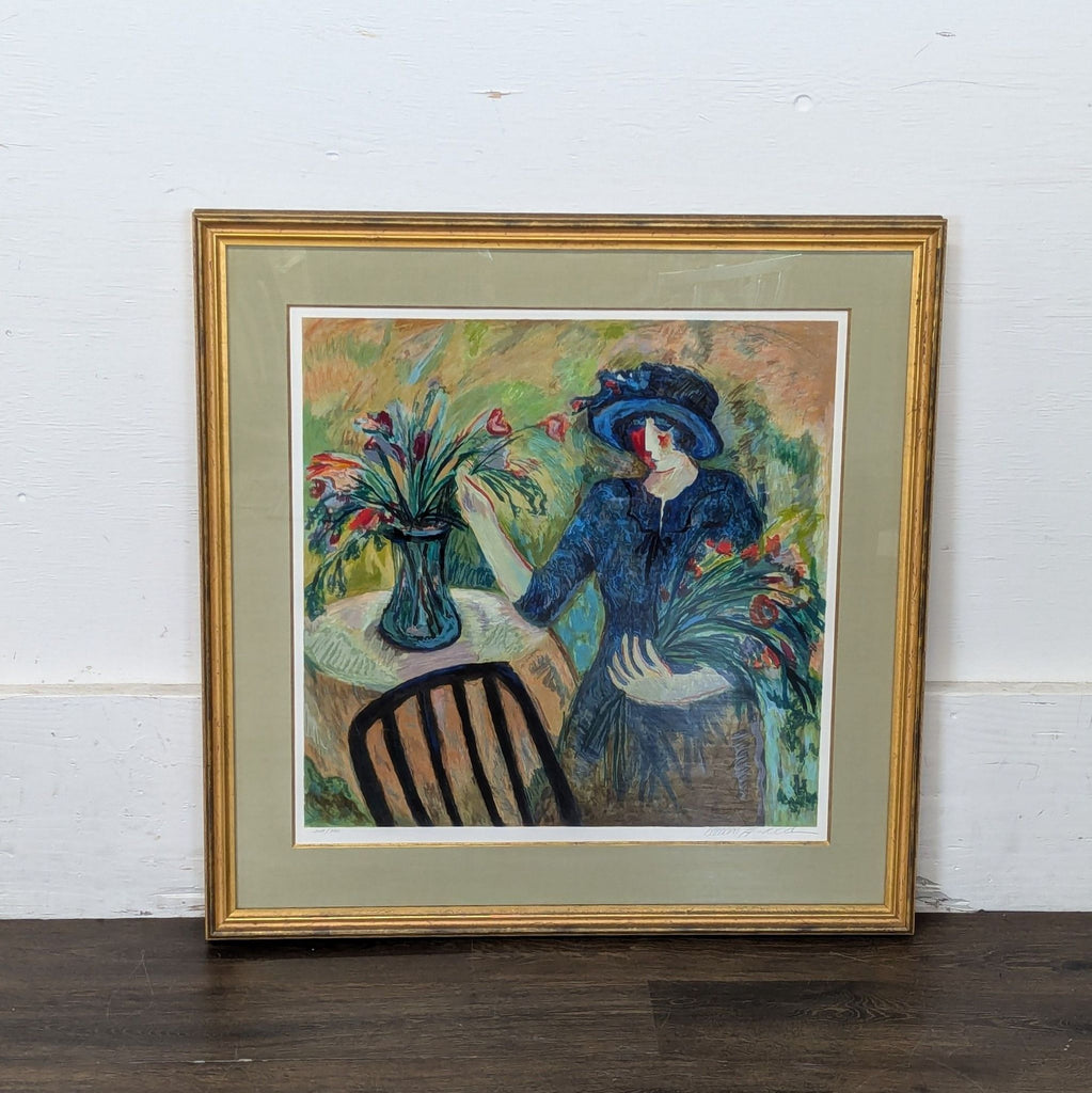 2. Colorful impressionist artwork depicting a woman with a bouquet, seated beside a vase of flowers, in gold frame.