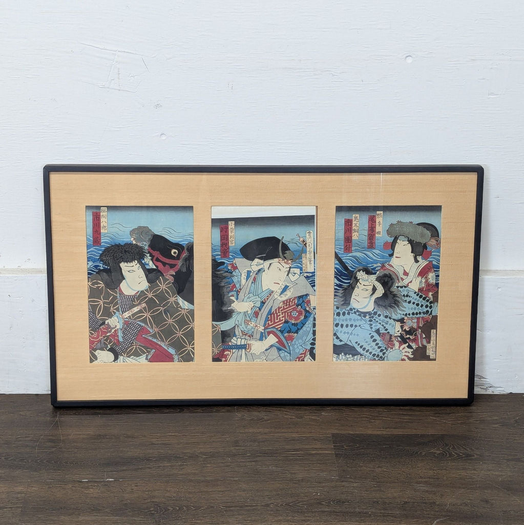 2. Framed Japanese woodblock triptych print displayed against a white wall, showing three warriors in vivid attire.
