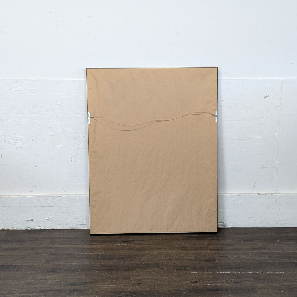 2. Rear view of framed print, showing plain brown backing paper and an attached hanging wire for wall display.