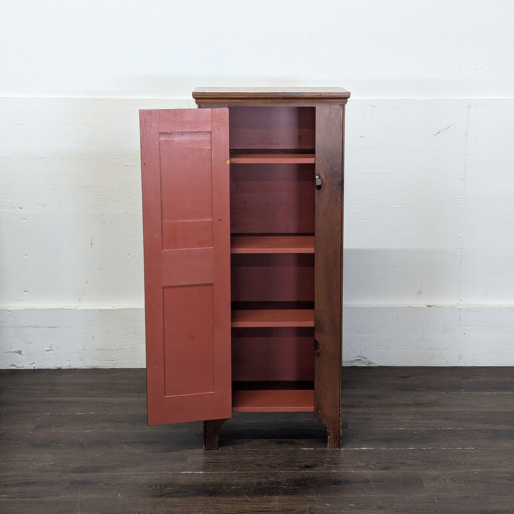 3. Open wooden cabinet showing red-shelved interior with multiple compartments for storage.