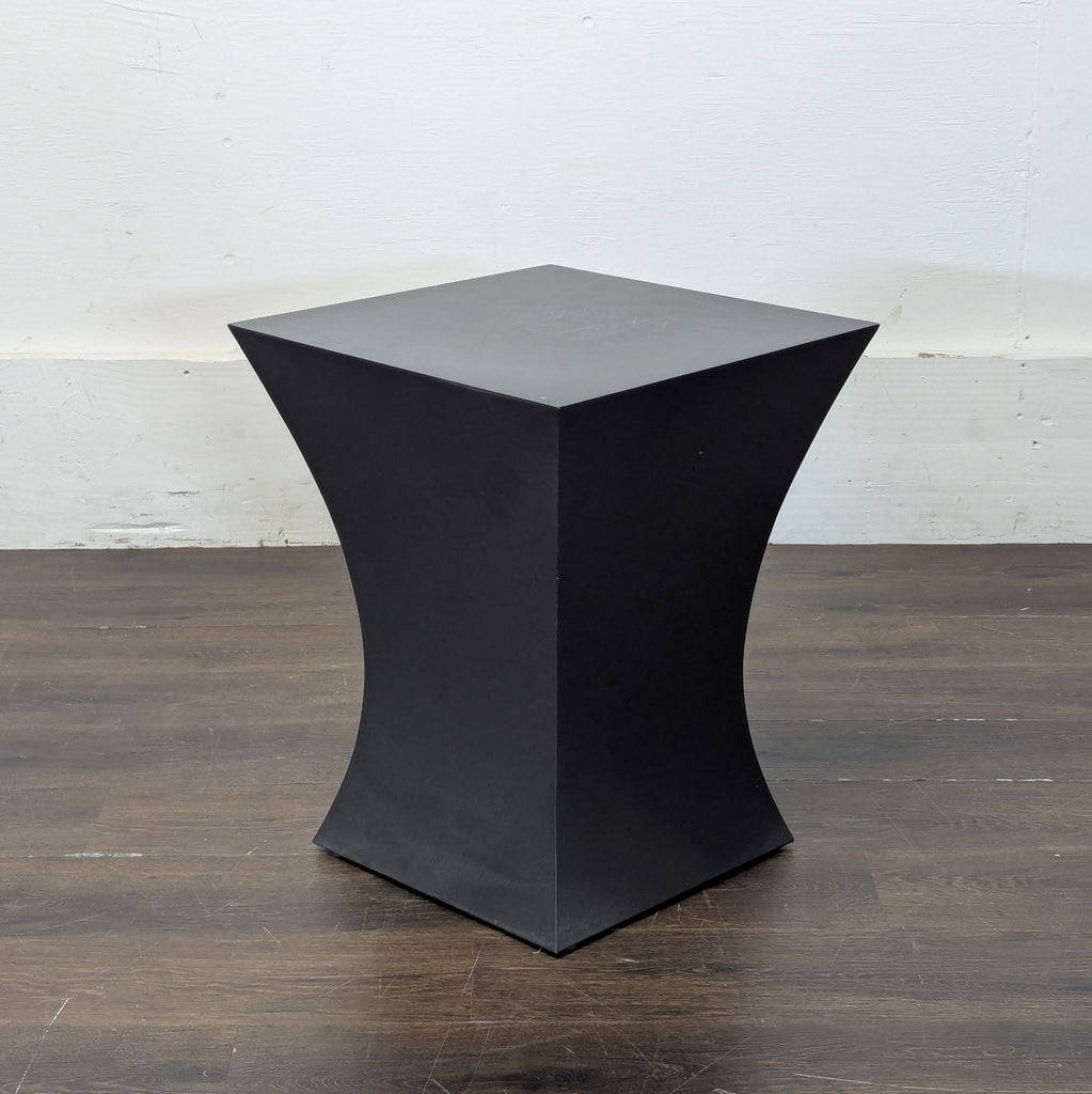 Room and Board black end table featuring a geometric hourglass design, shown from an angled perspective.