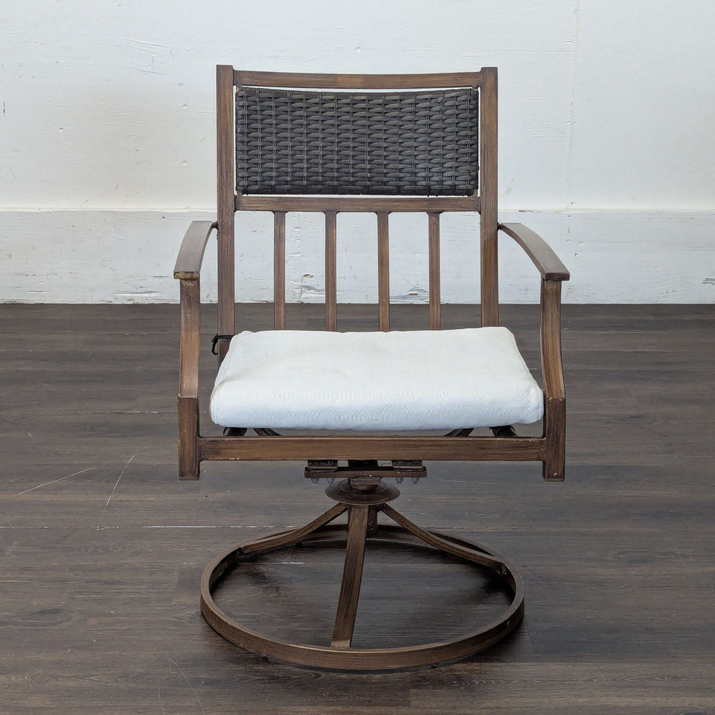 1. Orchard brand wooden chair with a woven back, light cushion seat, and circular swivel base on dark flooring.  