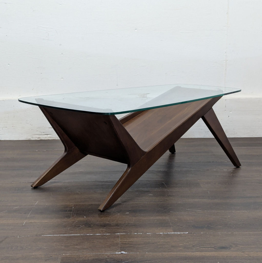 2. Minimalist coffee table featuring clean lines and a two-tone wood and metal finish.