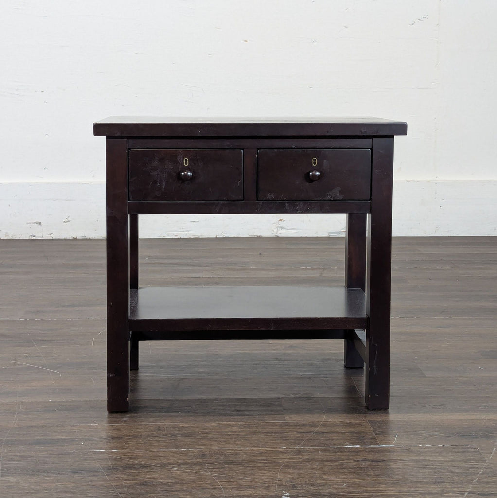 2. Elegant Pottery Barn end table featuring clean lines, natural wood finish, and sturdy legs.