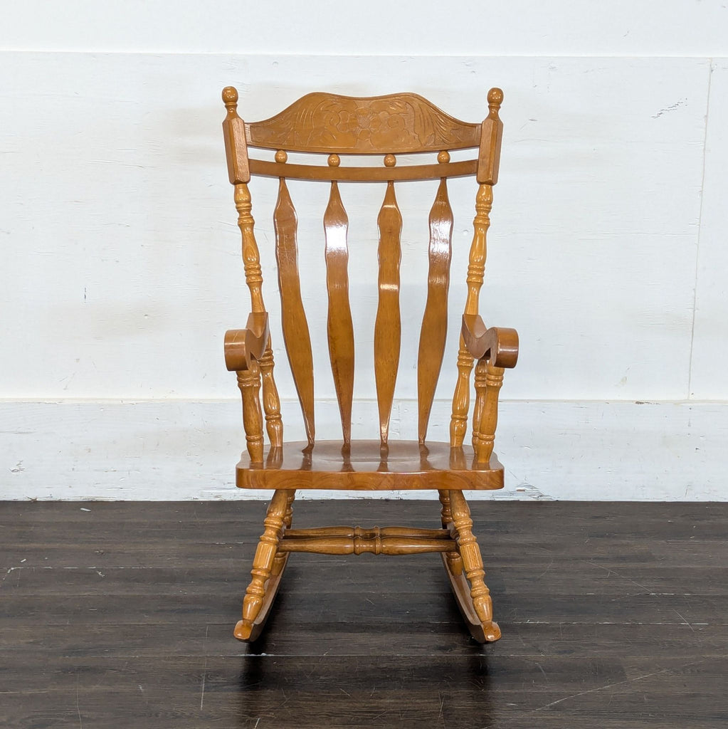 1. Classic wooden rocking chair with curved armrests and a high back, displayed on a plain background.