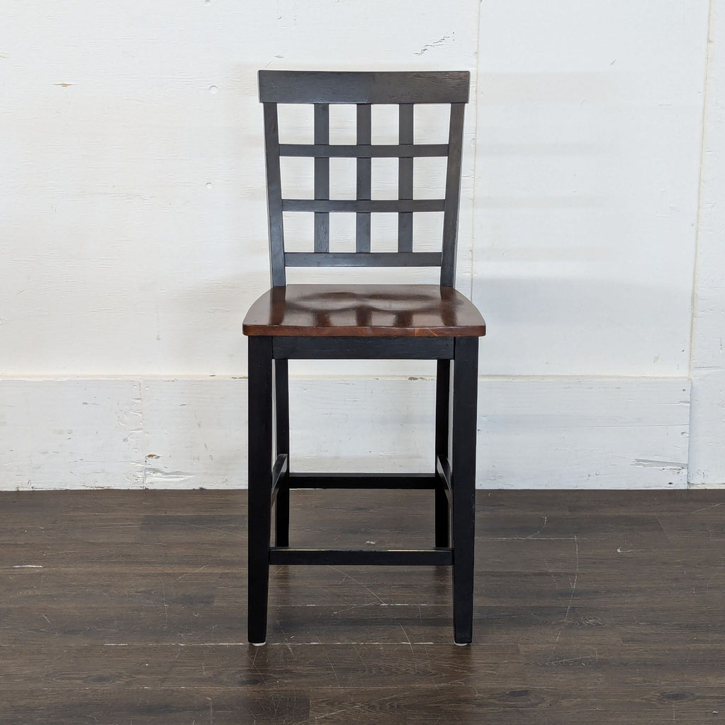 1. Black wooden dining chair with a grid backrest and brown seat, from the Dining table w/6 chairs set.  