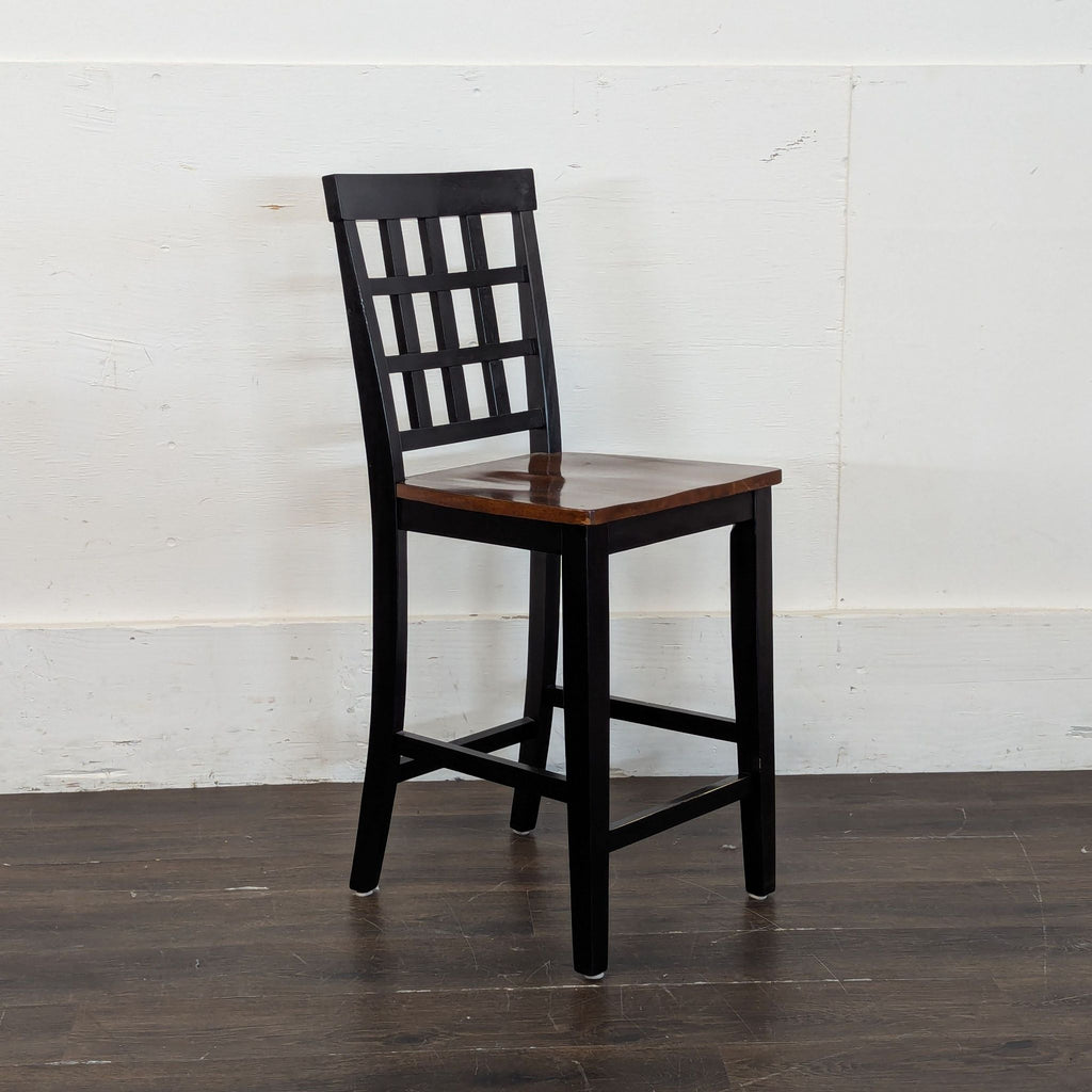 2. Side angle of a black wooden dining chair with a grid-patterned back and brown seat, Dining Set brand.