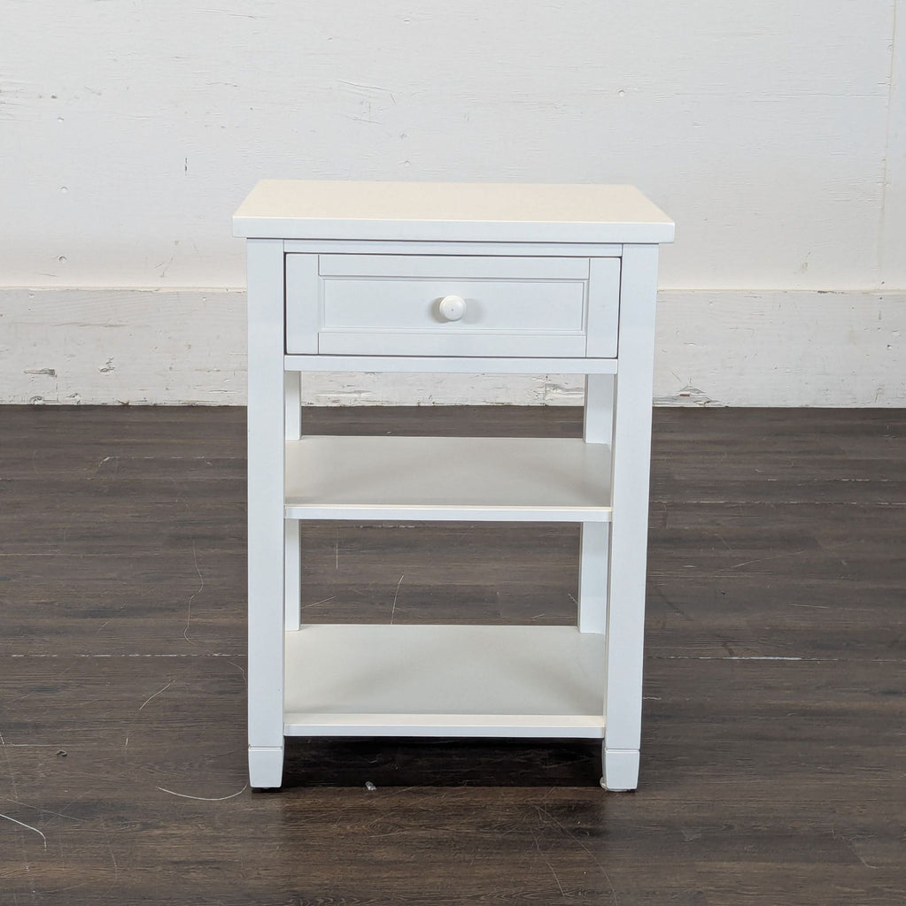 2. Modern Pottery Barn end table featuring a circular top and sturdy wood construction.  