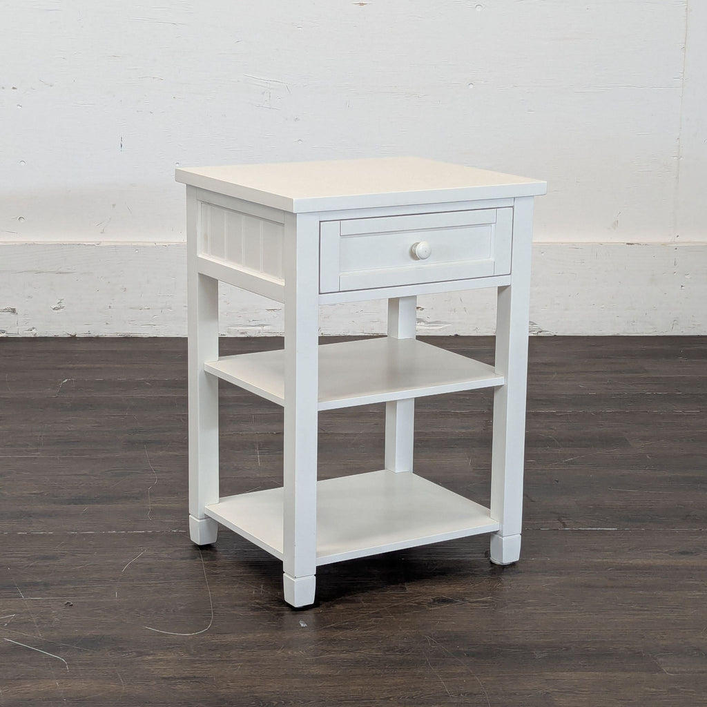 3. Wooden end table by Pottery Barn, ideal for living rooms, with a minimalist round design.