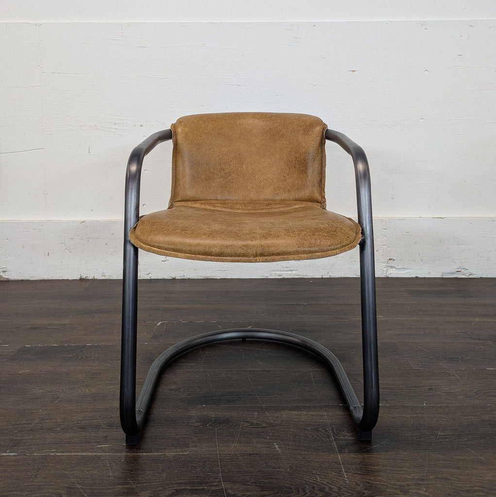 3. Contemporary lounge chair upholstered in soft leather, designed for a cozy and elegant lounge space.