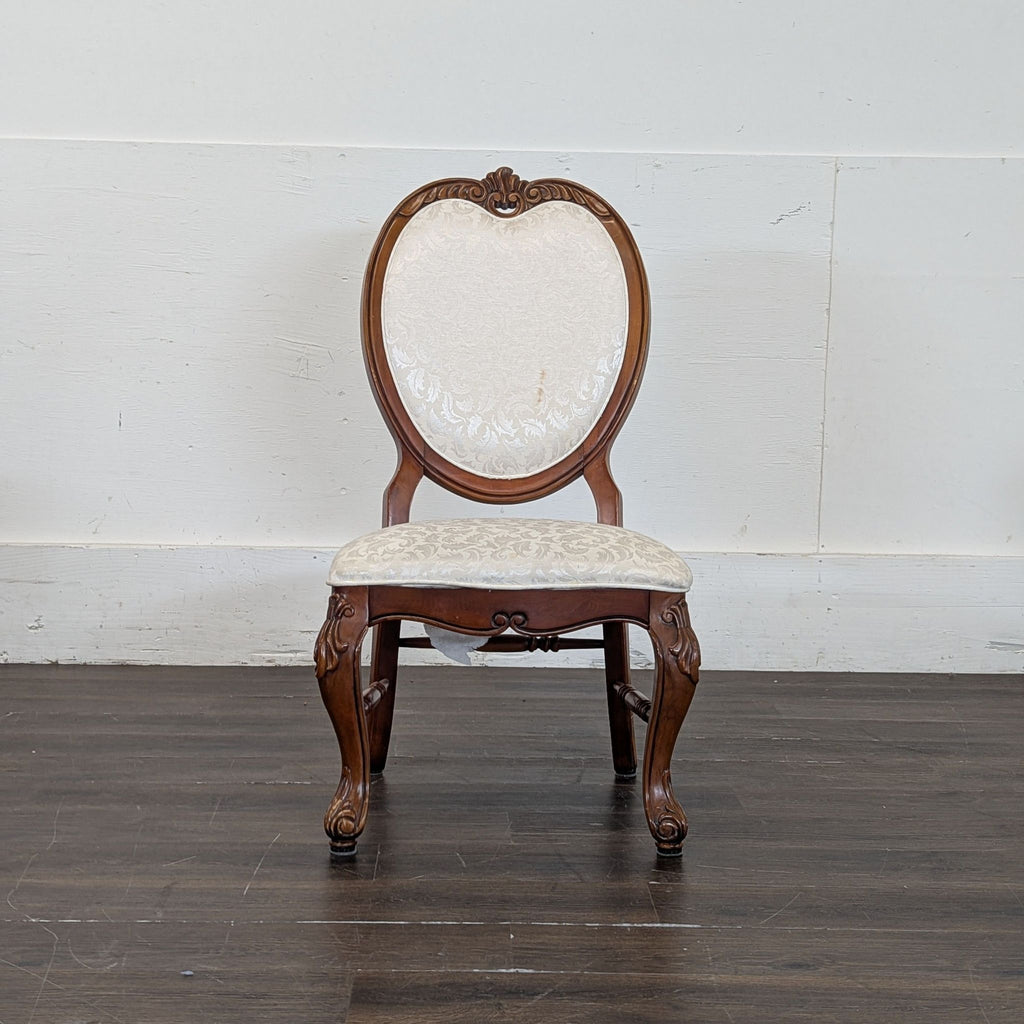 1. Modern dining chair with upholstered seat and wooden legs, positioned at a dining table.
