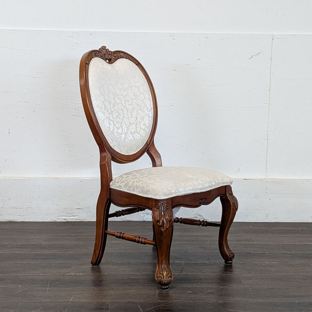 2. Sleek, minimalist dining chair featuring a high back and metal frame, set on a hardwood floor.