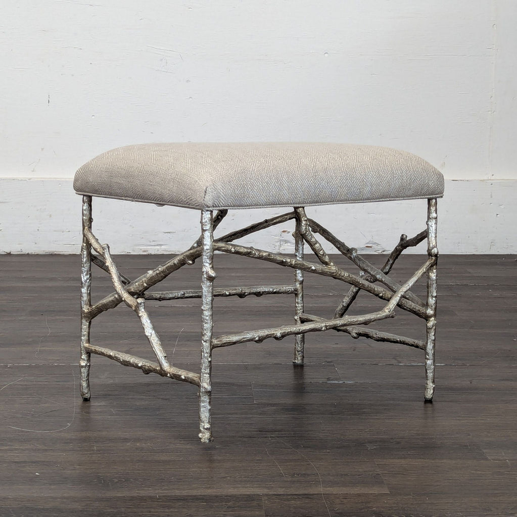 2. Contemporary John-Richard ottoman featuring twig-inspired metal legs and a textured beige cushion seat.