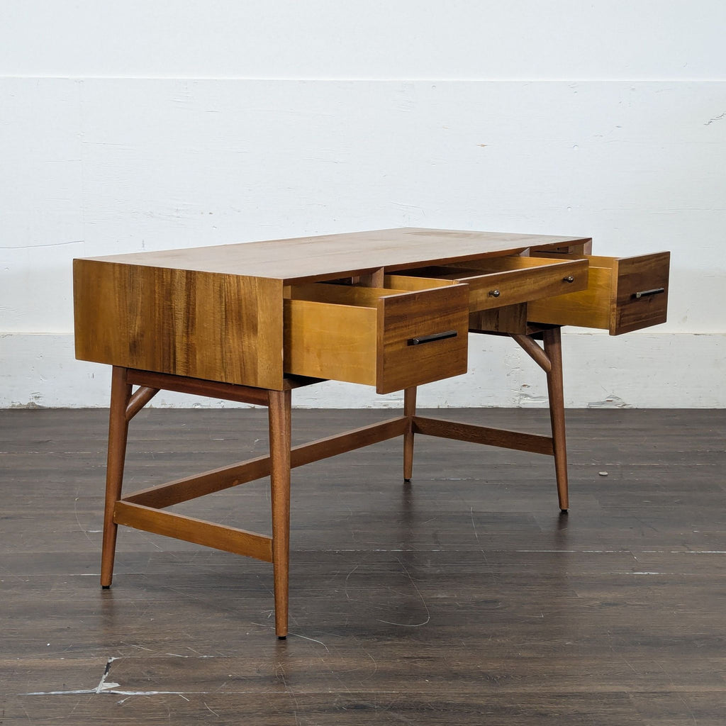 3. Wooden desk with all three drawers open, showcasing storage space and sturdy mid-century inspired construction.