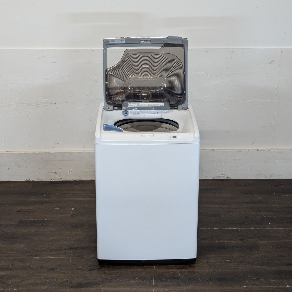 2. Samsung top-load washer or dryer with the lid open, revealing the drum and detergent compartments.