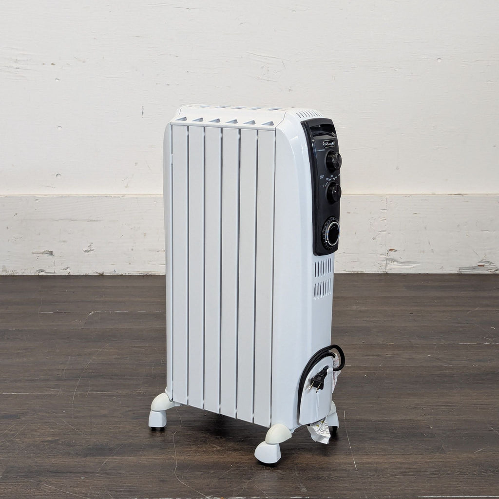 DeLonghi portable oil-filled radiator heater with control knobs, white body, on caster wheels, side angle view.  