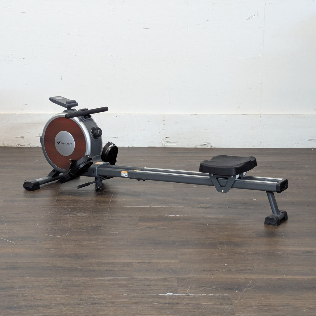3. Rowing machine branded fitness equipment, shown from side view with footrests and handle.