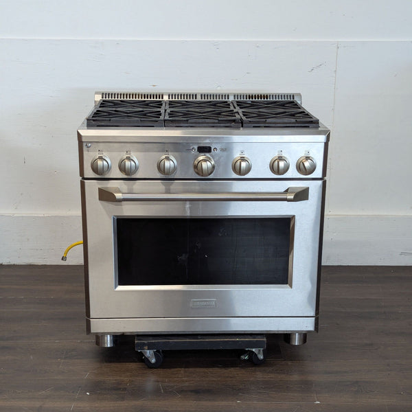 Monogram stainless steel stove & oven with matching control knobs and a sturdy oven handle.  
