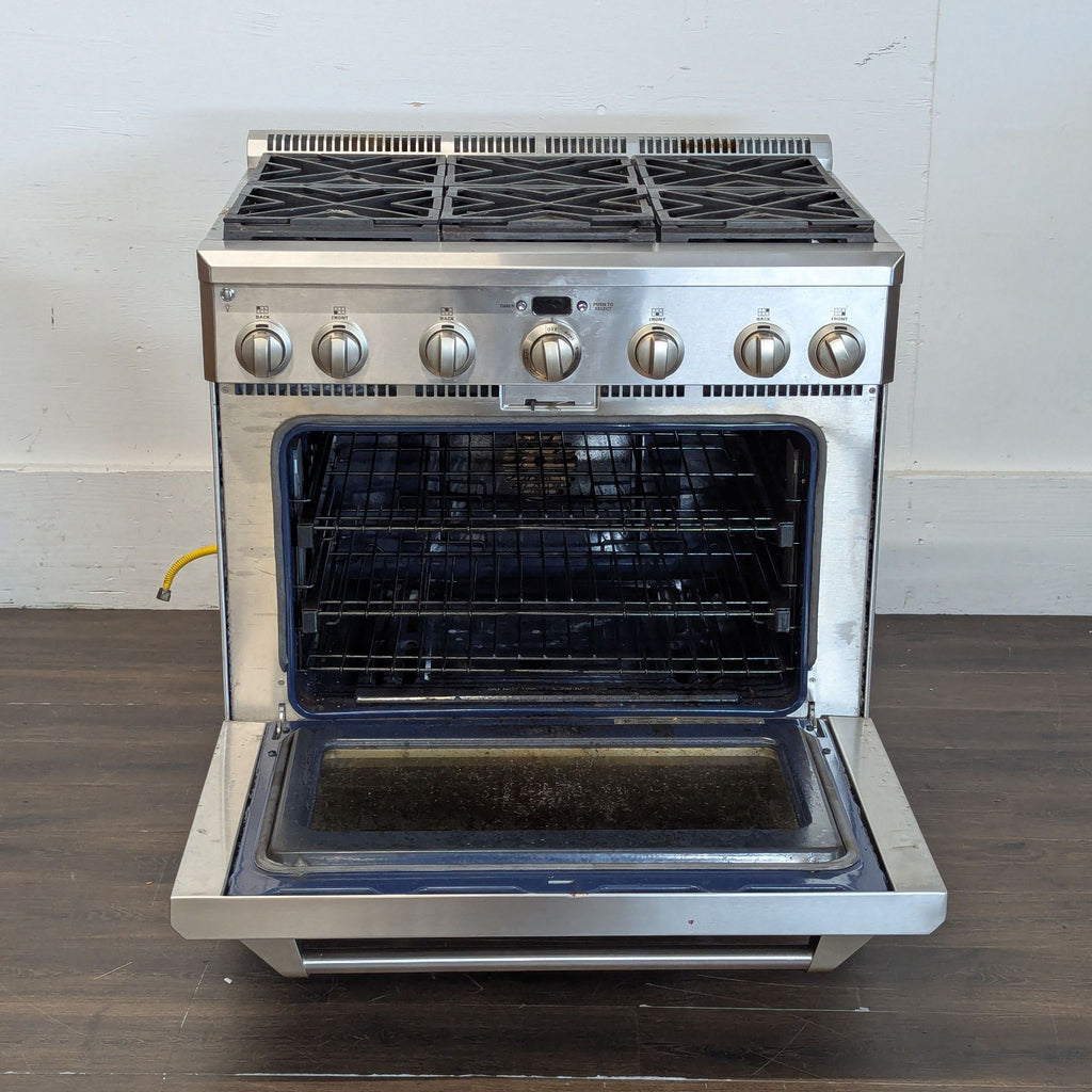 Commercial-grade Monogram range featuring dual-flame stacked burners and robust oven handle.  