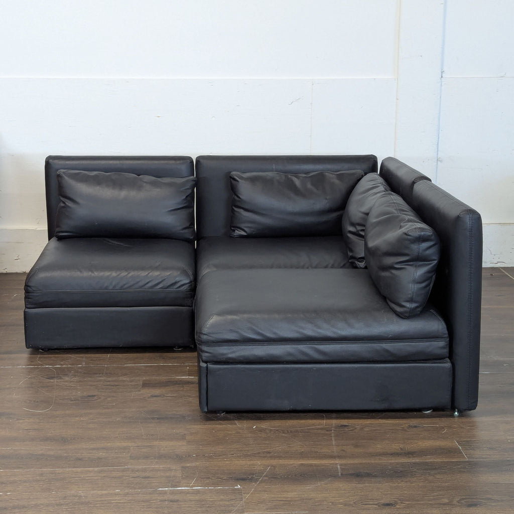 Excellent condition! 


Versatile modular sectional sofa is upholstered in black faux leather. This set includes a storage ottoman and a pull-out sleeper module. The modular design allows for various configurations to fit different living spaces. 

D