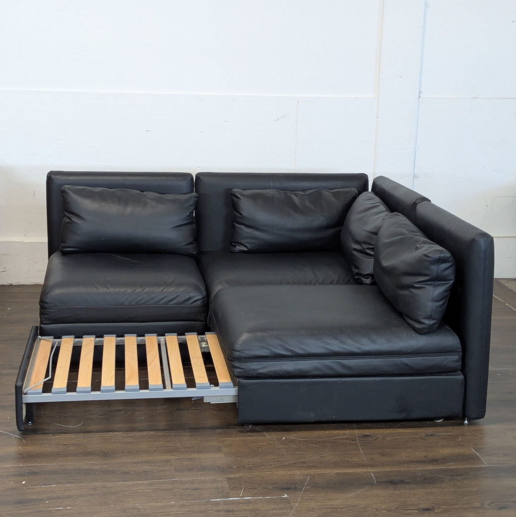 Excellent condition! 


Versatile modular sectional sofa is upholstered in black faux leather. This set includes a storage ottoman and a pull-out sleeper module. The modular design allows for various configurations to fit different living spaces. 

D