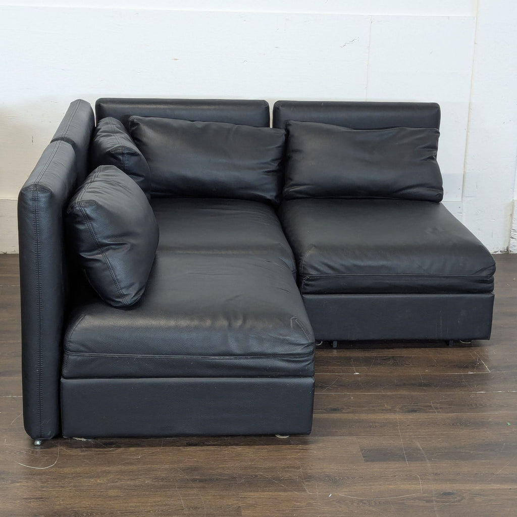 Excellent condition! 


Versatile modular sectional sofa is upholstered in black faux leather. This set includes a storage ottoman and a pull-out sleeper module. The modular design allows for various configurations to fit different living spaces. 

D
