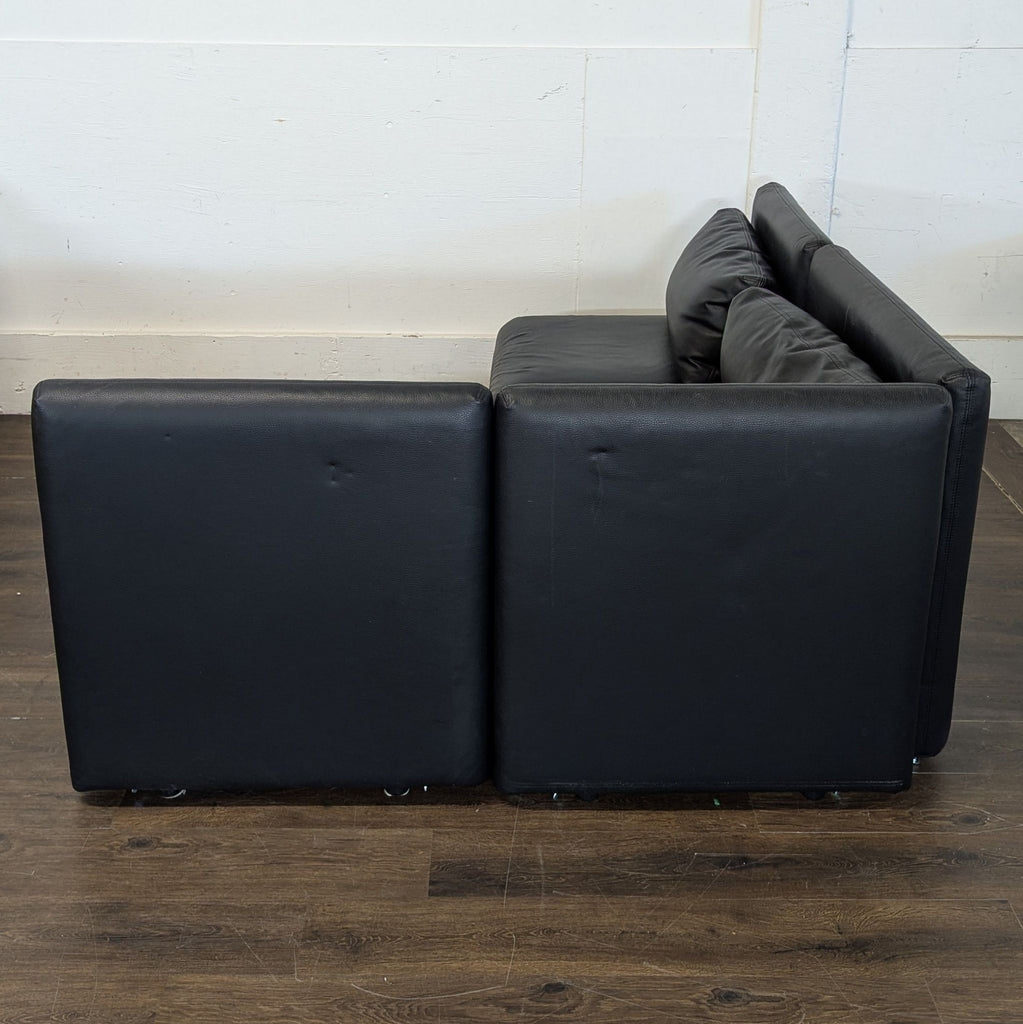 Excellent condition! 


Versatile modular sectional sofa is upholstered in black faux leather. This set includes a storage ottoman and a pull-out sleeper module. The modular design allows for various configurations to fit different living spaces. 

D