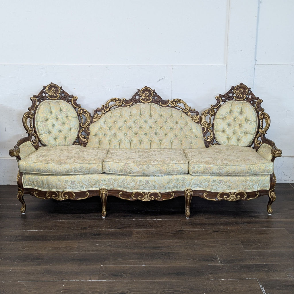 3. Hausske-Harlen 3-seat sofa featuring damask fabric, gold wood accents, and tufted backs on dark wood floor.