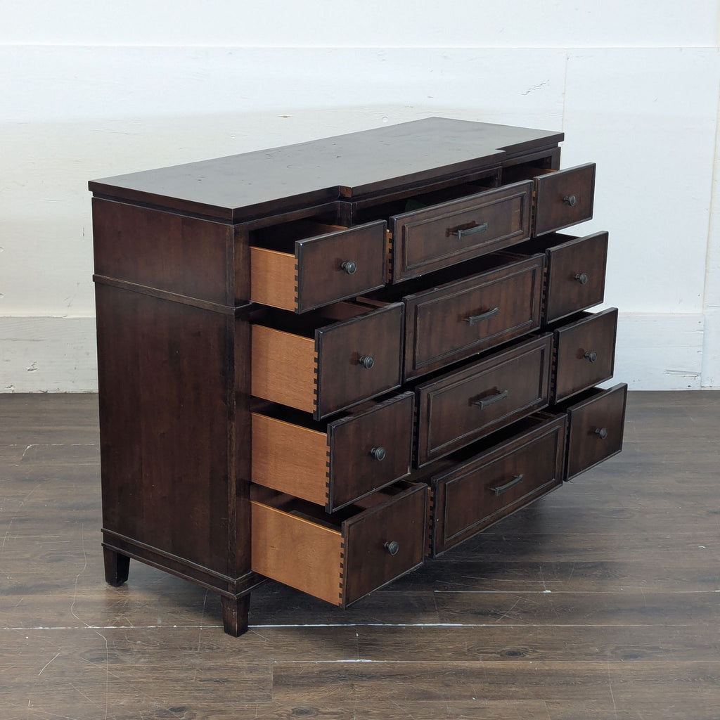 2. Sleek black dresser featuring spacious drawers and a smooth top, ideal for bedroom storage.