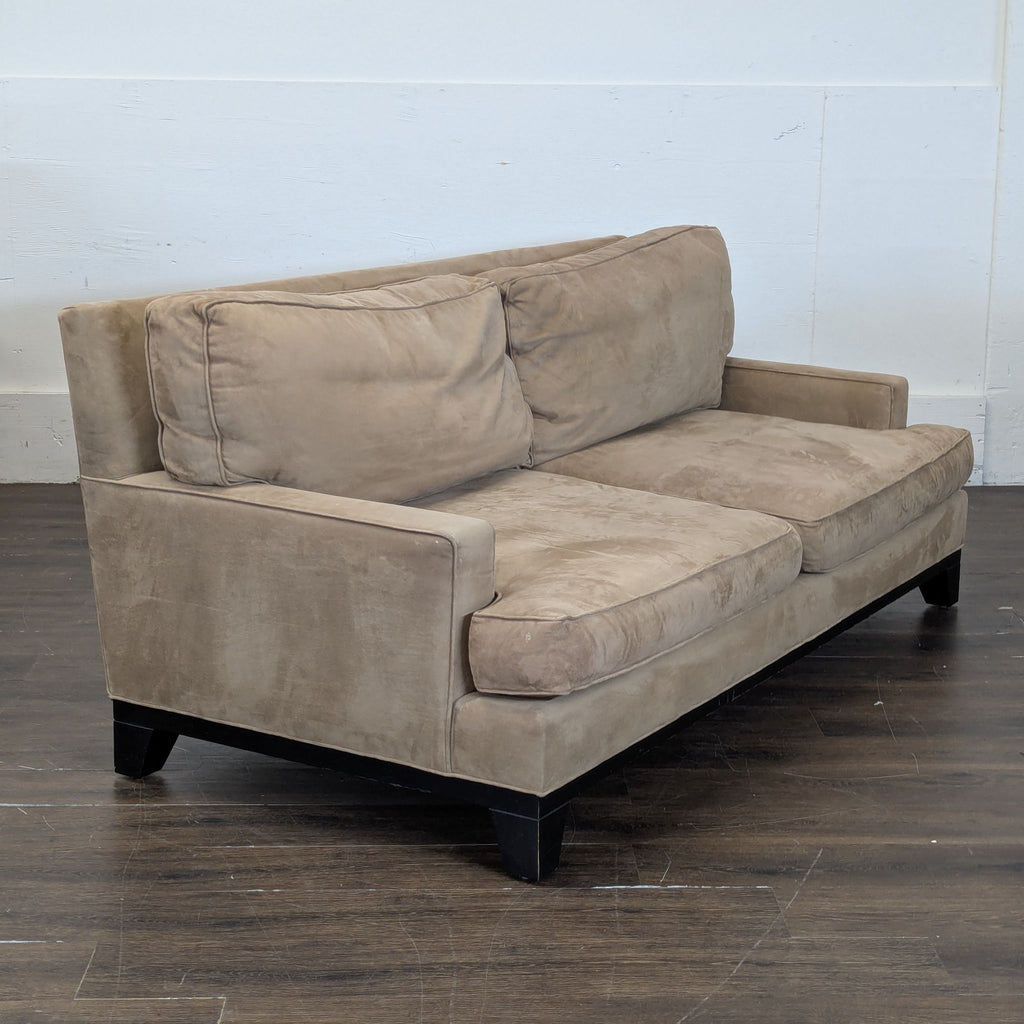 2. Compact gray loveseat featuring tufted backrest and slim armrests on a white background.