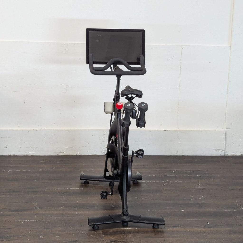 2. Multi-functional workout bench with padded seat and backrest in a fitness studio.