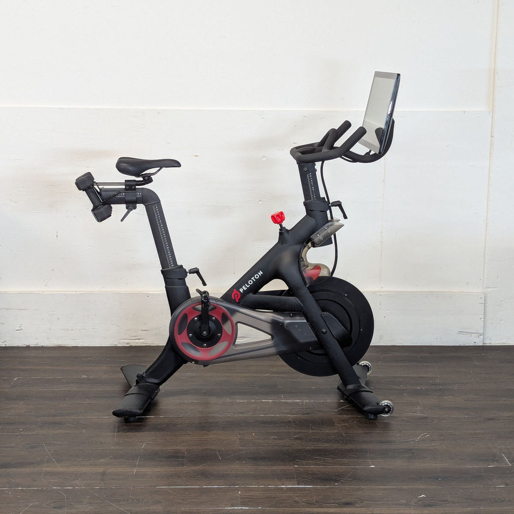 1. Black adjustable dumbbells with textured grips resting on a gym floor.