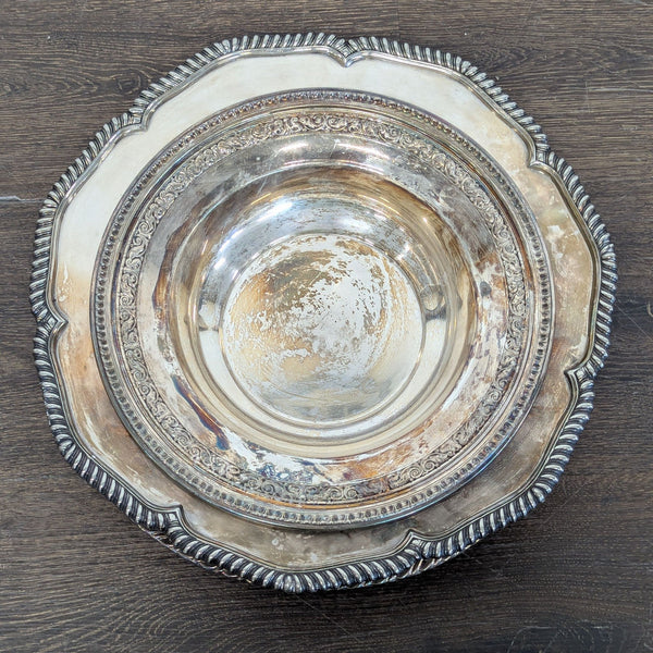 1. Ornate vintage silver dishware bowl with intricate edging, viewed from above on a wooden surface.