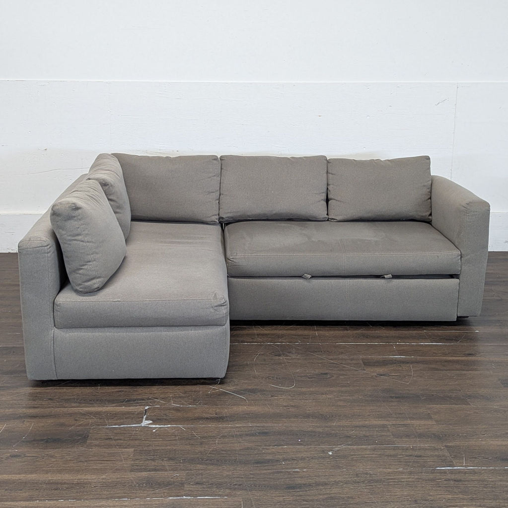 Modern sectional couch with built-in ottoman extension and spacious storage compartment underneath.