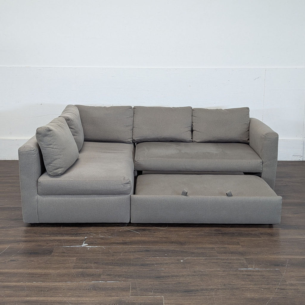 Room & Board sectional includes a pullout ottoman and practical under-storage; fits contemporary living rooms.