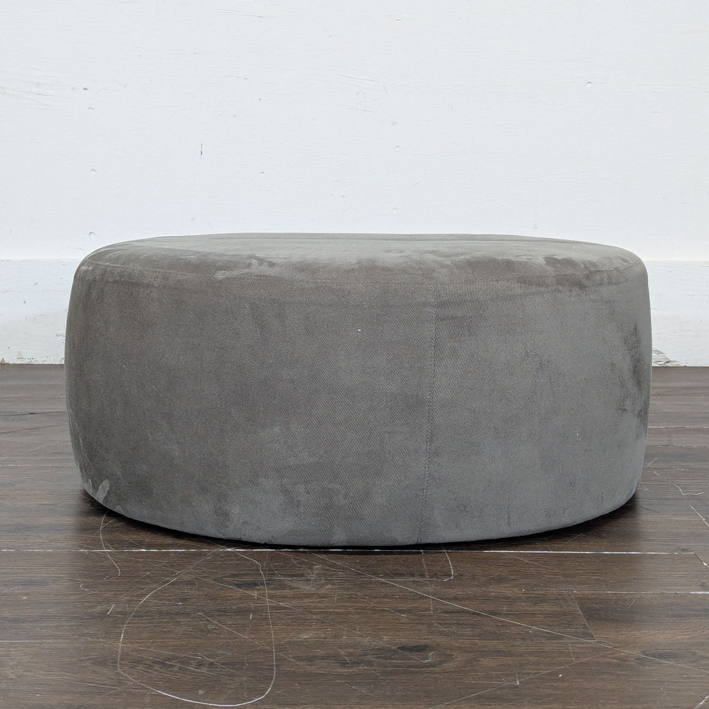 3. Elegant Room & Board Lind ottoman in neutral fabric, suitable for seating or as a footrest; original price $600.