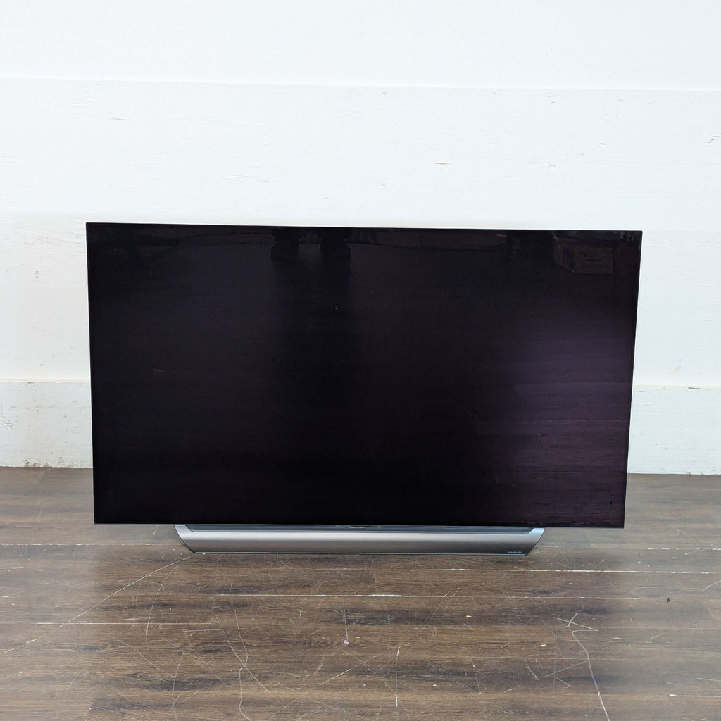 1. Sleek flat-screen TV on a modern stand with a vivid, colorful display.