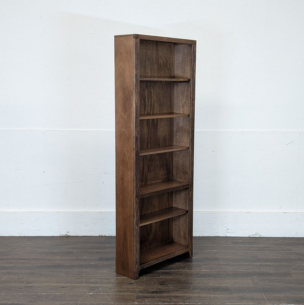 1. Tall wooden bookshelf with five open shelves, holding books and decorative items.