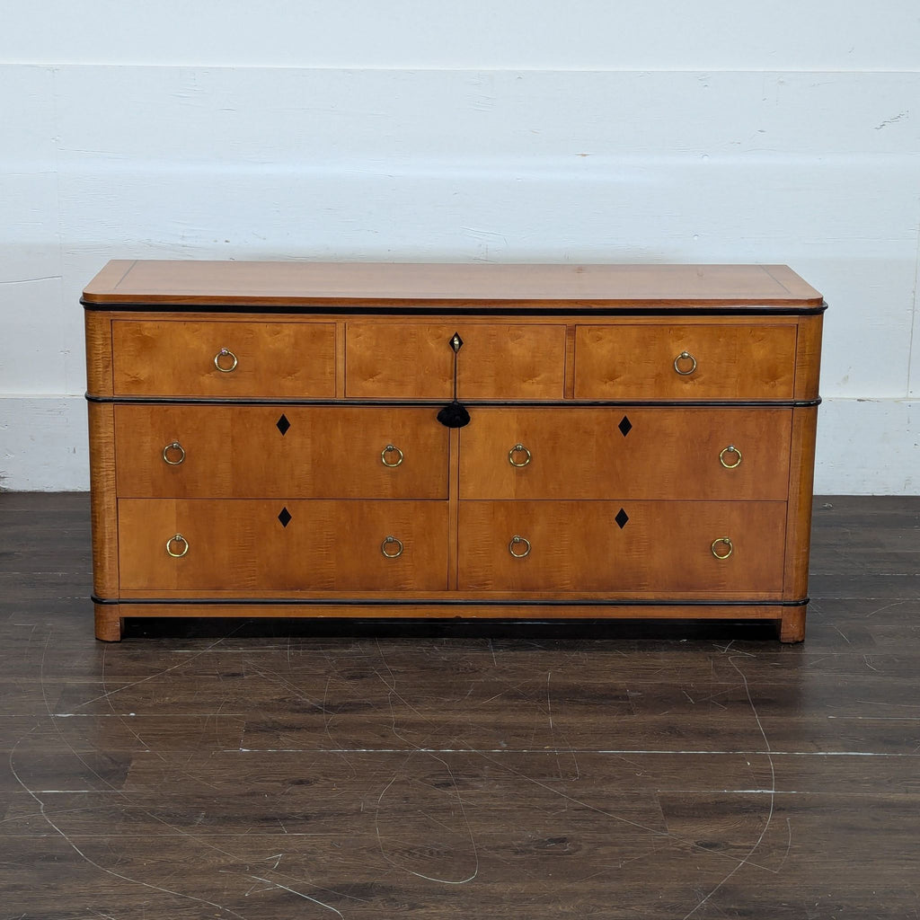 1. Front view of a National Mt. Airy dresser with eight drawers, ring pulls, and black diamond accents.